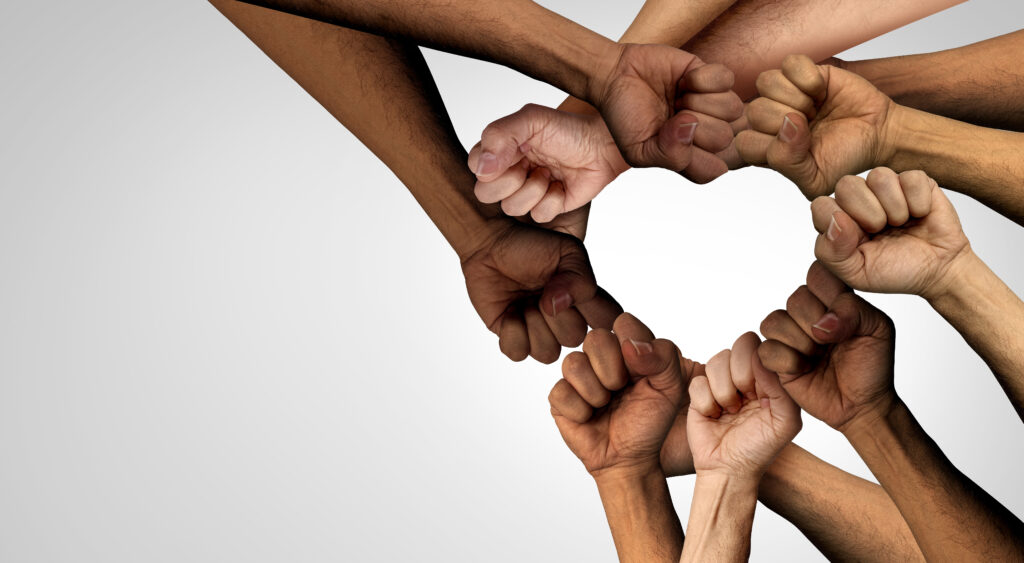 A group of fists arranged into a heart shape.